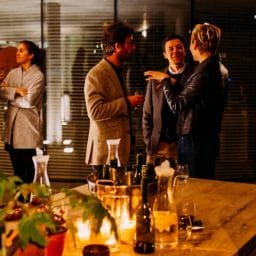 People talking at a holiday dinner party.