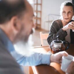 Husband and wife having coffee together at the breakfast table.