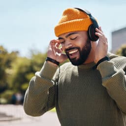 Music, headphones and happy man at park outdoor, listening to music.