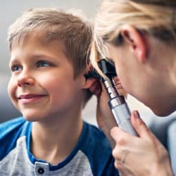 Young boy getting an ear exam.